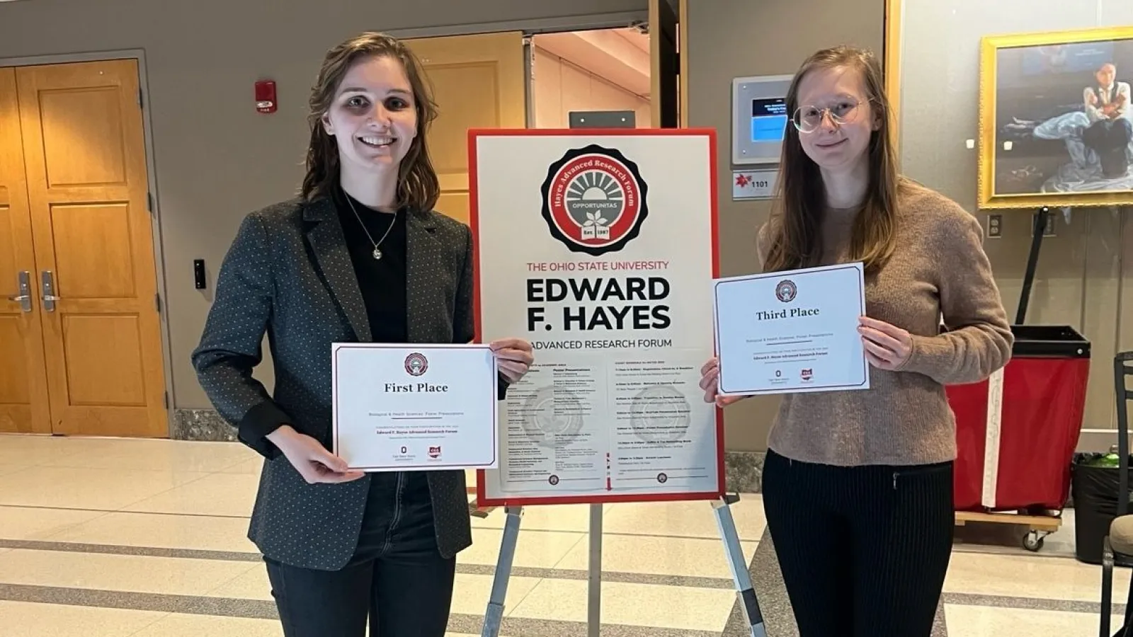 Annika Chura and Electra Coffman holding award certificates
