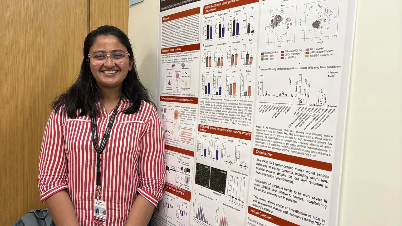 Ayushi Das in front of her research poster