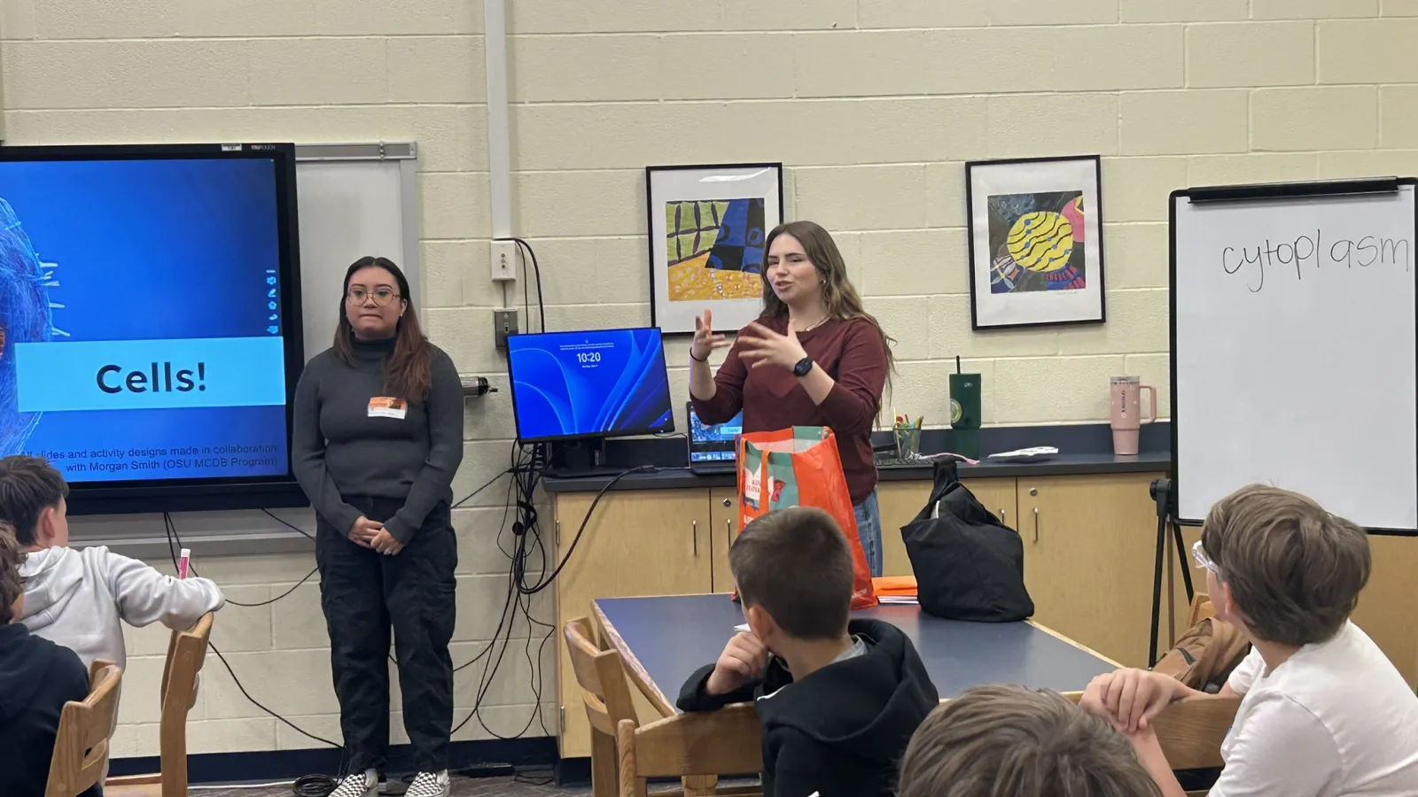 Carmen Rodriguez and Remi Pastierik presenting in front of a classrom