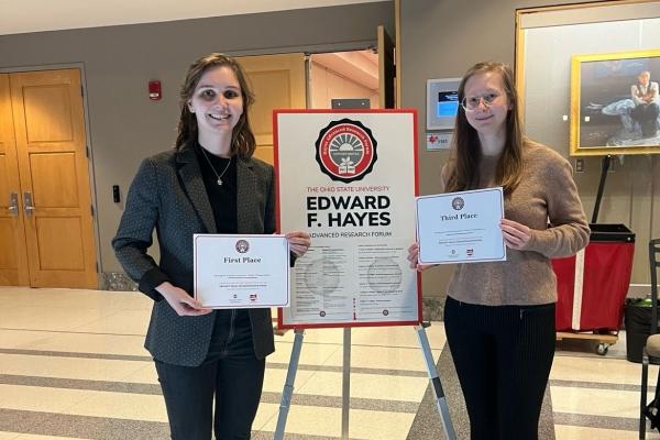 Annika Chura and Electra Coffman holding award certificates